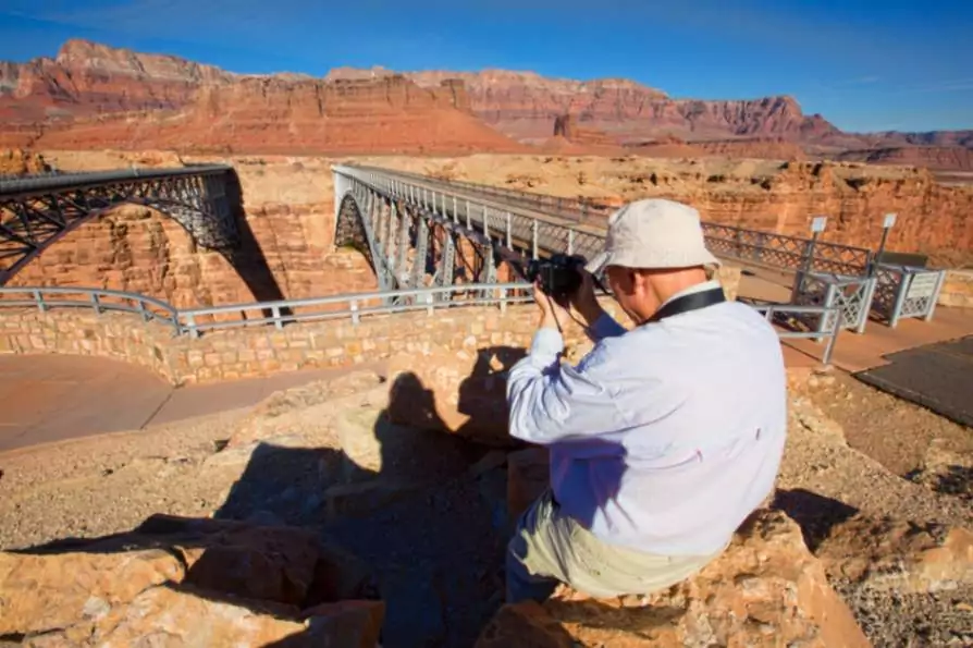 Lees ferry arizona man taking picture at the Navaho bridge