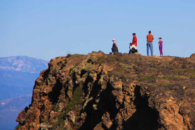 Hikers and people on top of the rocks, Channel Island National Park overlooking.