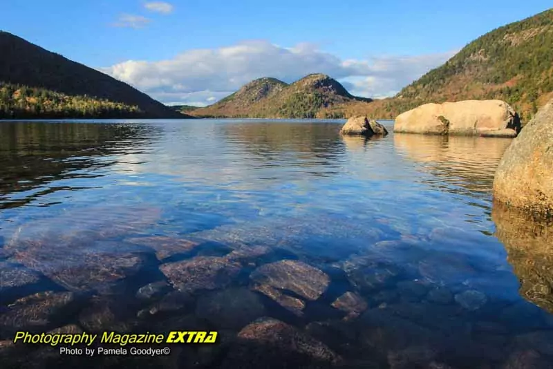 Jordan pond with blue clouds and the mountains in the background.