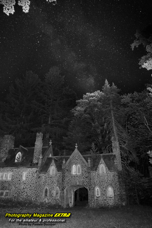 Very dark castle with the milky way above it in the dark