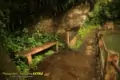 A bench with green lush foliage and a water pond.