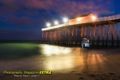 An alien see through in front of the Belmar Pier at night time. Long exposure trick photography.