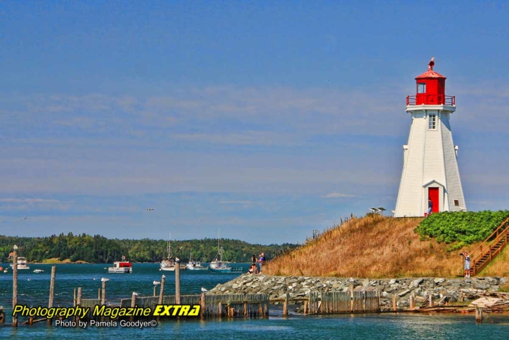 Campobello Island Canada G Red and white lighthouse overlooking the waters.