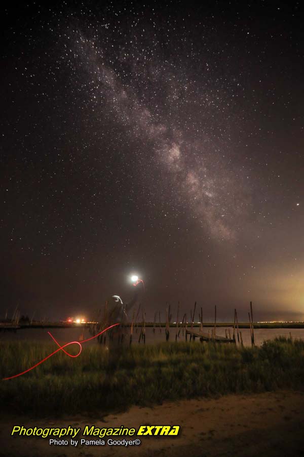 alien with torch at tuckerton New Jersey in front of the water with a torch in the sky.