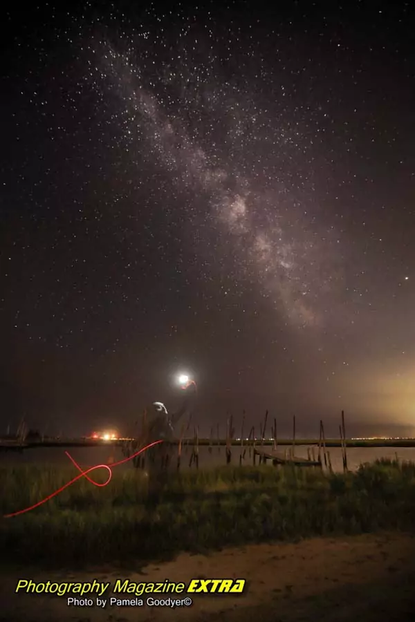 alien with torch at tuckerton New Jersey in front of the water with a torch in the sky.