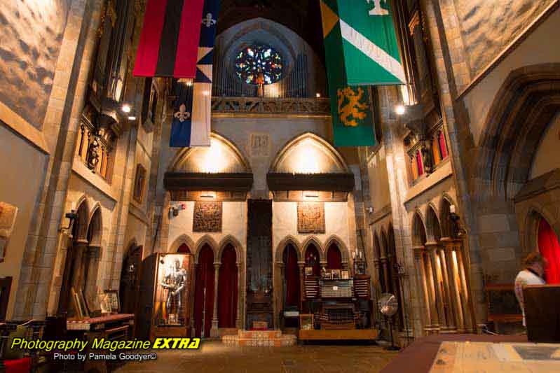 Hammond castle. Interior room with a statue and old flags.
