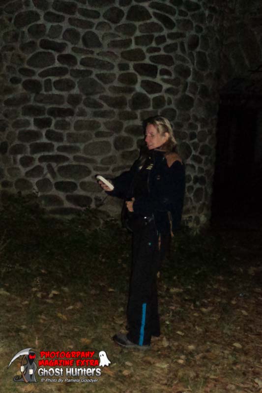 Pamela Goodyear with her ghost hunting meter in front of Dundas Castle while ghost hunting in upstate New York.