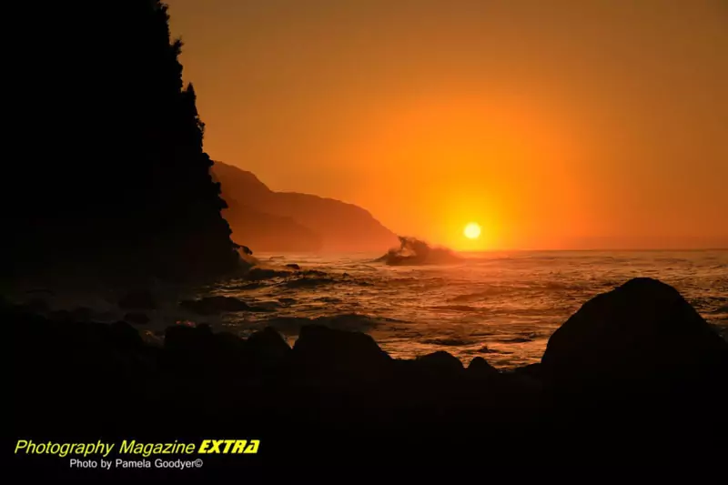 Sunset in the waves. bright orange, yellow sky with a silhouette foreground of rocks.