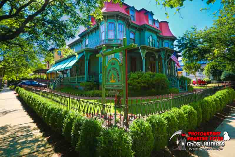 The Queen Victoria beautiful bed and breakfast in Cape May in full color on an angle with the fence.
