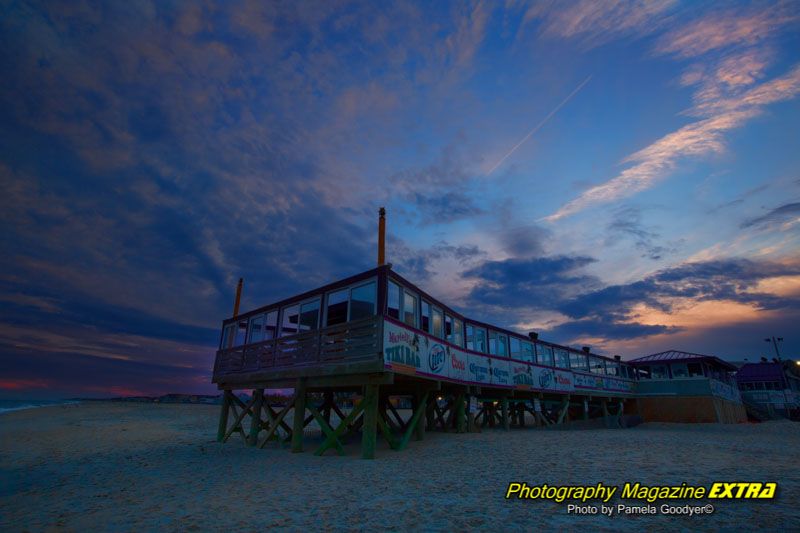 Jenkinsons boardwalk with a colorful sky on the beach.