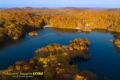 fall foliage at a dark blue lake with brilliant fall colors