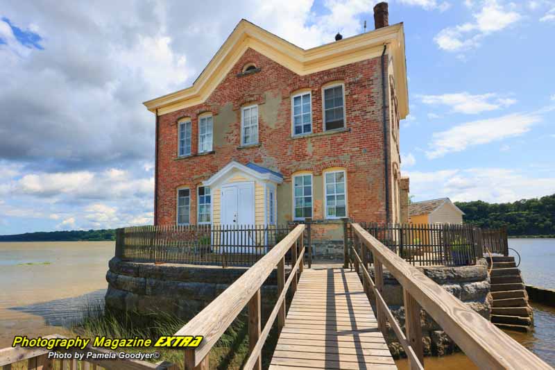 Saugerties lighthouse showing in the bright blue sky.
